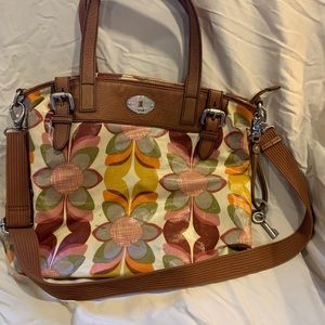 Fossil coated fabric tote.  Cream with brown accents and multi-colored pattern.